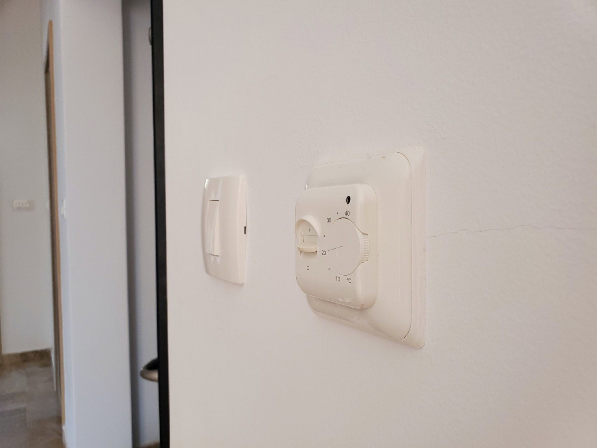 Underfloor heating thermostat and light switch in the apartment, Pržno, Montenegro. Climate control in the penthouse.