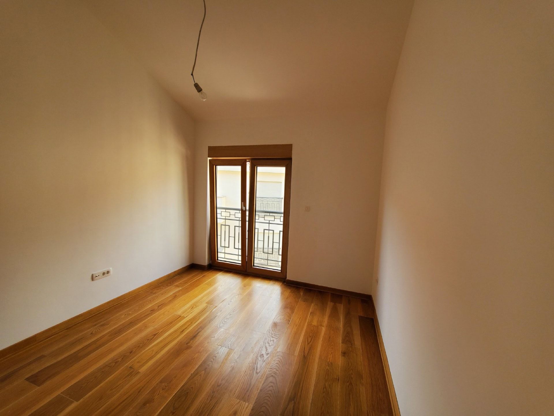 Bright bedroom with parquet flooring and access to the balcony in a penthouse, Pržno, Montenegro.