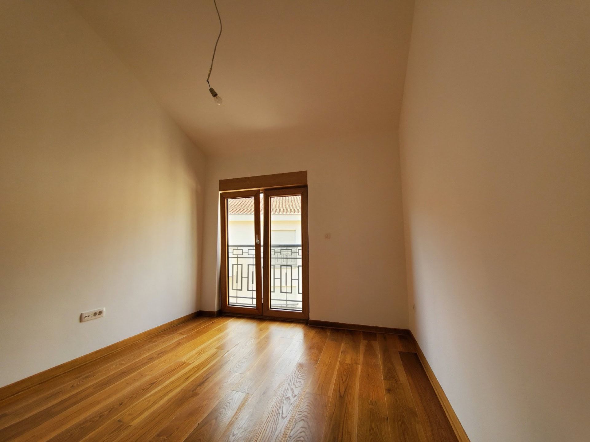 Bright bedroom with parquet flooring and access to the balcony in a penthouse, Pržno, Montenegro.