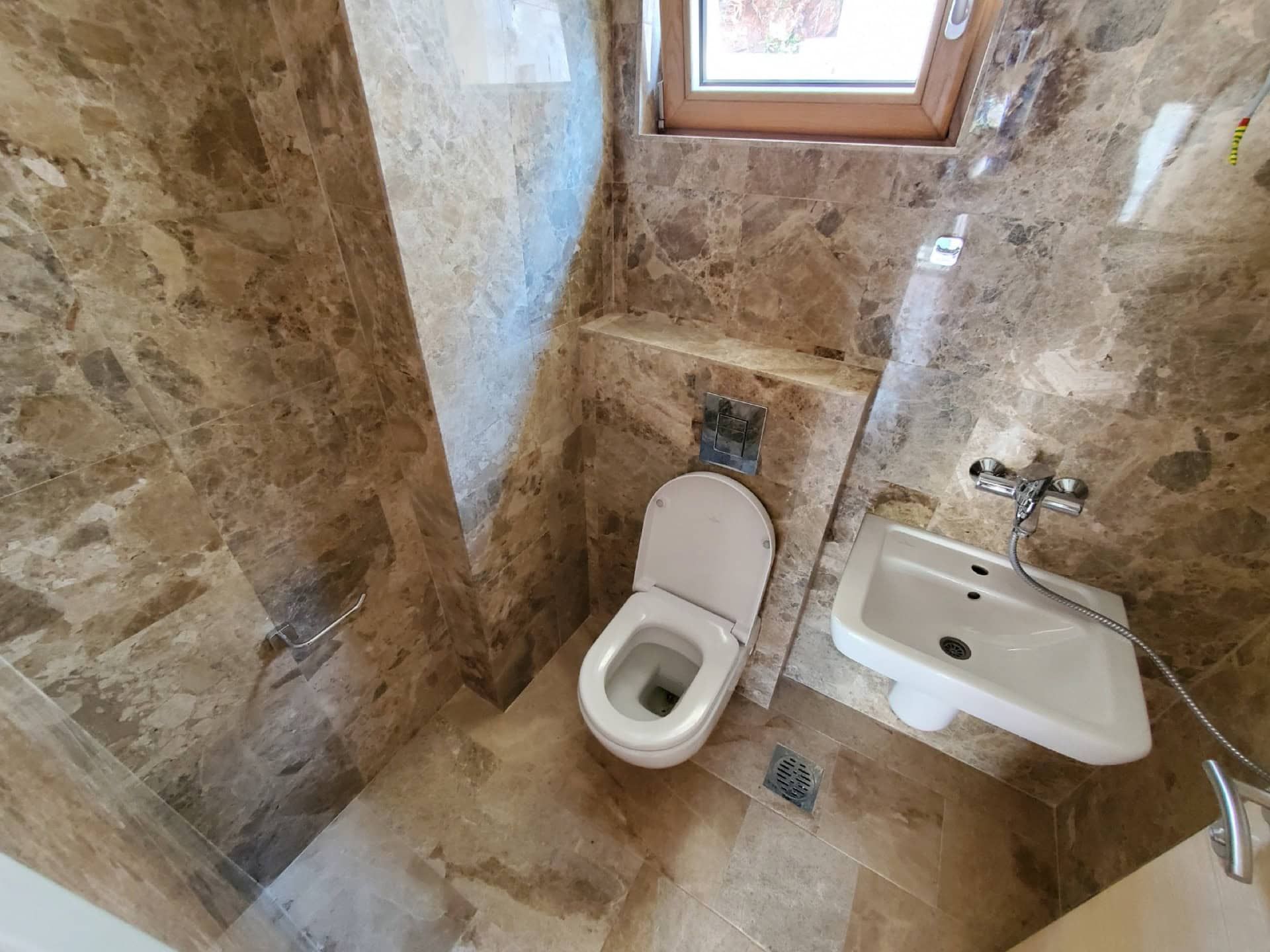 Modern bathroom with brown marble finishes in a penthouse, Pržno, Montenegro.