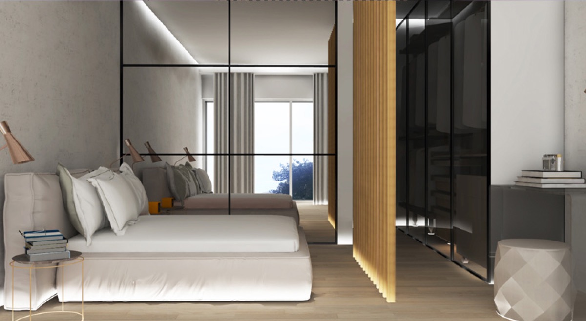 Modernes Schlafzimmer in der Wohnanlage Budva, Montenegro: Doppelbett, Spiegeltrennwand und begehbarer Kleiderschrank mit Beleuchtung.