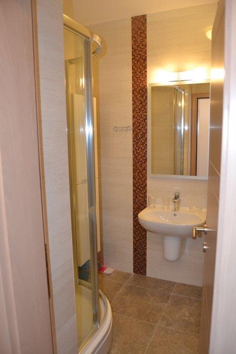 Modern bathroom with a shower cabin and mosaic finishes in an apartment, Becici, Montenegro.