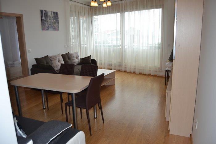 Bright living room with dining area and panoramic windows in an apartment, Bečići, Montenegro.