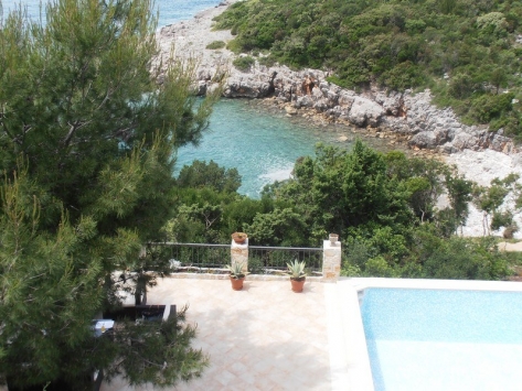 Blick auf den Pool und die Meeresbucht von der Terrasse der Villa in Luštica, Montenegro: Panorama der Küste und Landschaftsgestaltung.