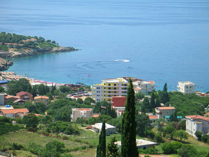 Panoramic view of the sea, beach, and the resort village of Dobri Vody in Montenegro from a bird’s-eye view.