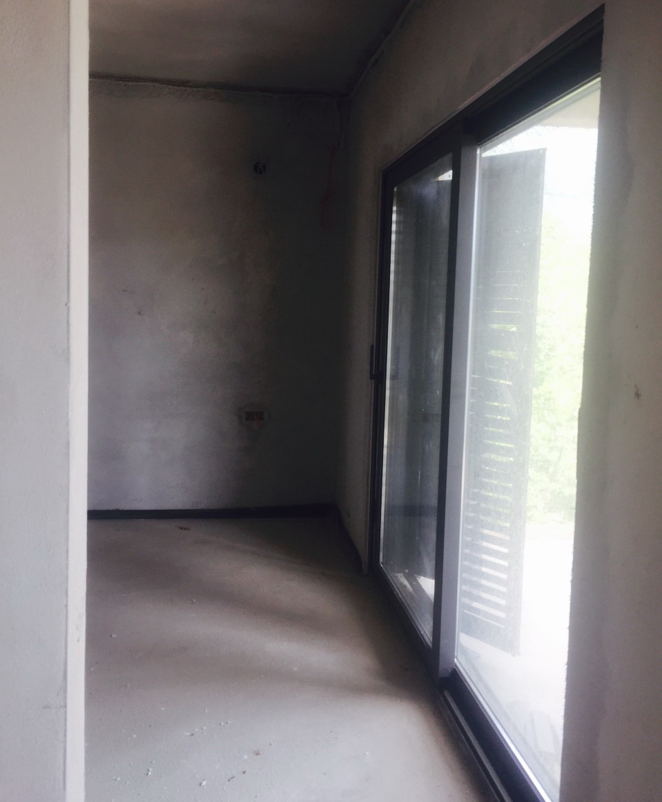Wohnzimmer im Ausbau in einer Villa in Herceg Novi, Montenegro: Panoramaverglasung und Zugang zur Terrasse.