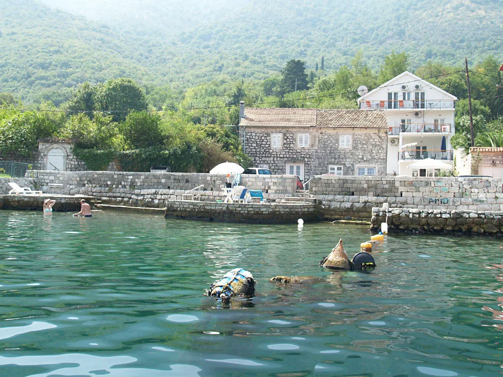 Stone villa by the sea in Stoliv, Montenegro: private beach, terraces, mountain views, and the bay’s crystal-clear water.