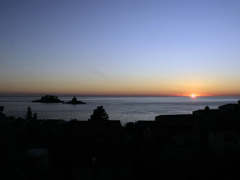 Petrovac, Karadağ’da, №984 numaralı villanın terasından deniz ve adalar üzerinde gün batımının panoramik manzarası.