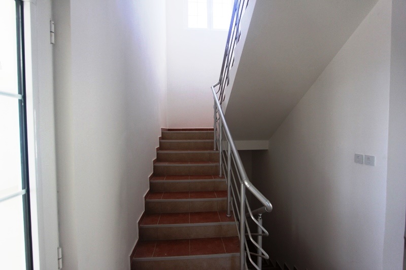Staircase with tiled steps and metal railings in the interior of a villa in Dobra Voda, Montenegro.