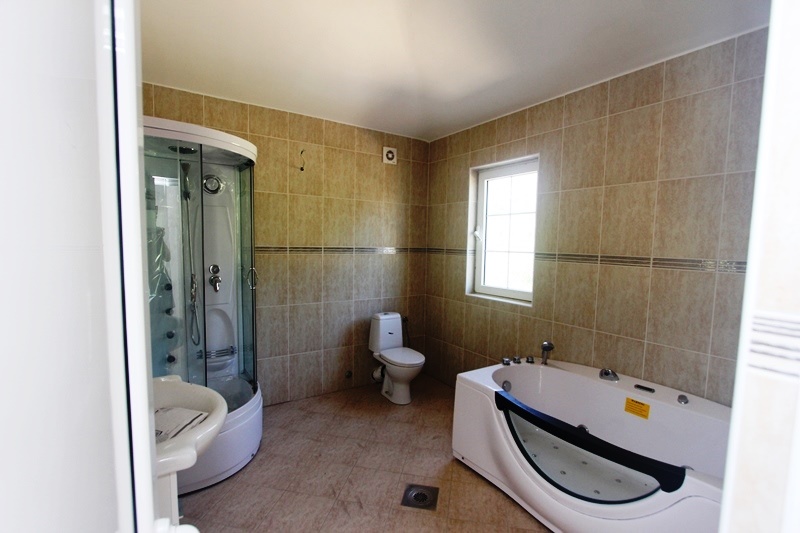 Bathroom with a jacuzzi and shower cabin in a villa in Dobra Voda, Montenegro: modern tile finish.