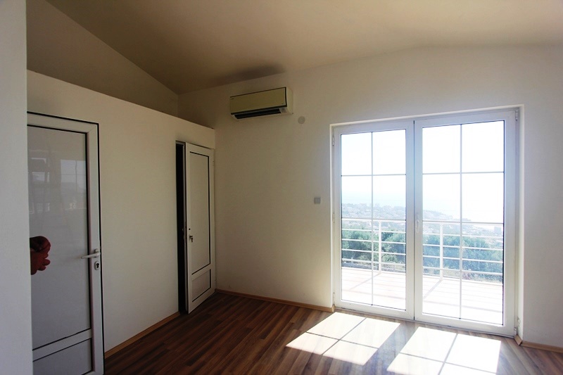 Bright bedroom with panoramic access to the terrace and sea view in a villa, Dobri Vody, Montenegro.