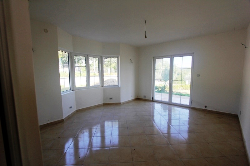 Bright living room with panoramic windows and tiled floor in a villa in Dobra Voda, Montenegro.