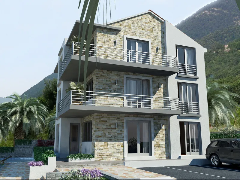 Taş cepheli, balkonlu ve dağ manzaralı üç katlı modern ev.