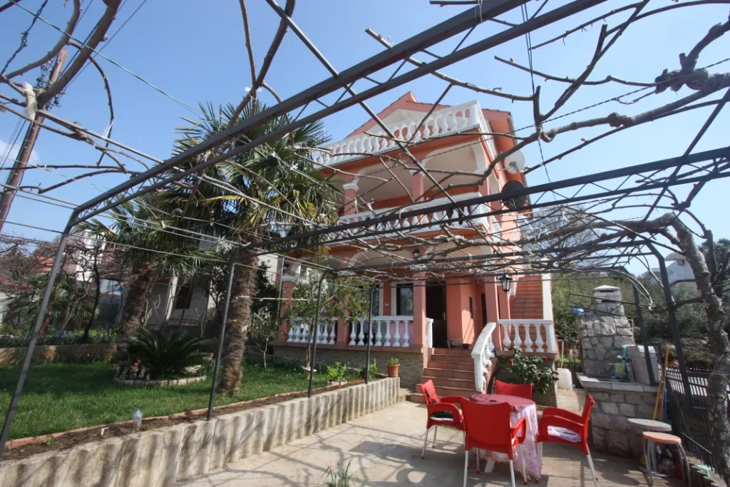 Dreistöckiges Haus in Uteha, Montenegro: Terrasse mit Weinpergola, Grillbereich, Garten und Palmen.