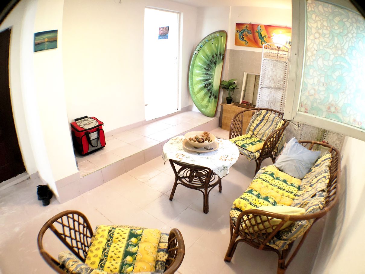 Cozy living room with rattan furniture in a house for sale in Risan, Montenegro: bright interior with tiled floors.
