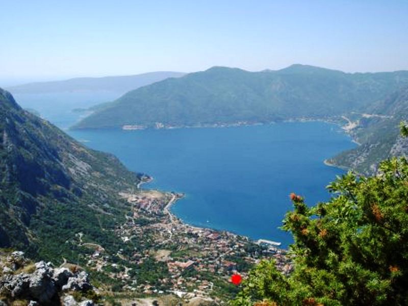 Panoramic view of Kotor Bay and the town of Risan in Montenegro from a mountainside elevation.