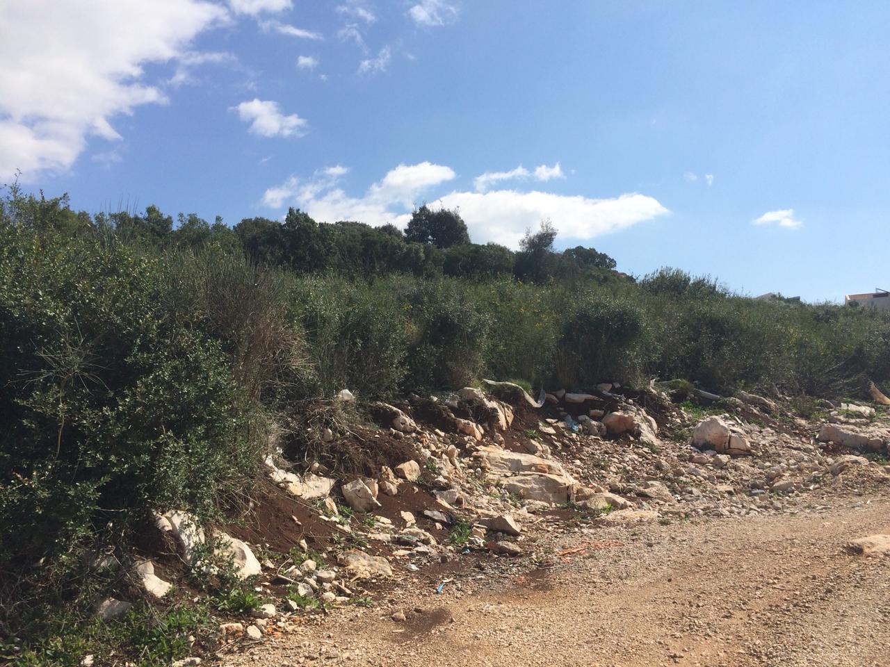 Grundstück zum Bau in Dobri Vody, Montenegro: hügeliges Gelände mit Steinen und grünen Sträuchern.