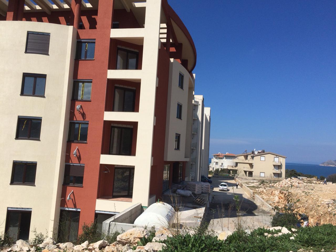 Moderner Wohnkomplex in Dobrih Voda, Montenegro: Blick auf die Gebäudefassade und das angrenzende Gelände am Meer.