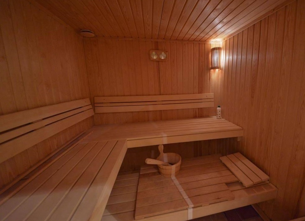 Wooden sauna with benches and bath accessories in a villa in Herceg Novi, Montenegro.