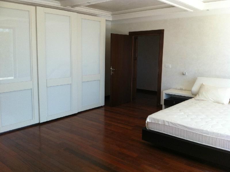 Spacious bedroom in a villa in Herceg Novi, Montenegro: double bed, built-in wardrobe, and parquet flooring.