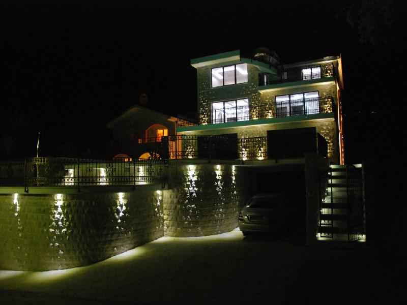 Three-story villa with facade lighting at night, terraces, and parking in Herceg Novi, Montenegro.