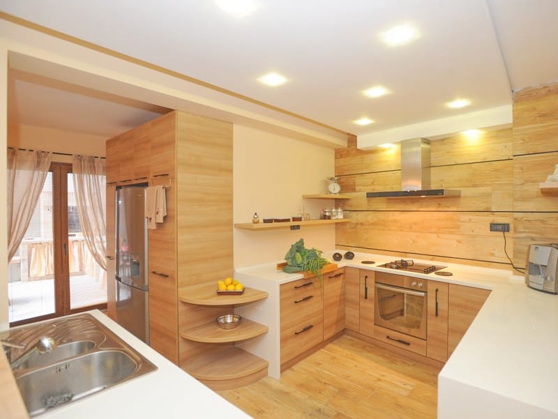 Modern kitchen with wood finishes and built-in appliances in a villa in Bigovo, Montenegro.