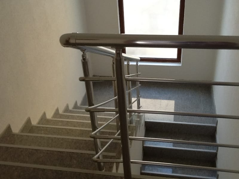 Staircase with metal railings and stone step finishes in a house, Shushan, Montenegro.