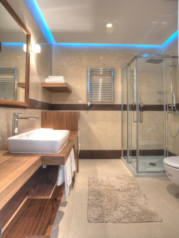 Modernes Badezimmer mit Duschkabine und Holzverkleidung in einer Wohnung in Budva, Montenegro.