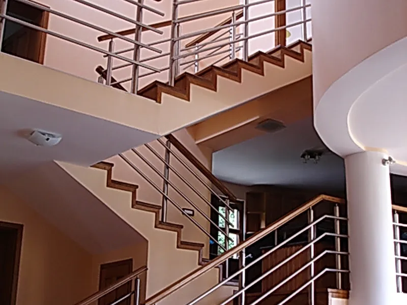 Modern staircase with wooden steps and metal railings in a villa interior, Utjeha, Montenegro.