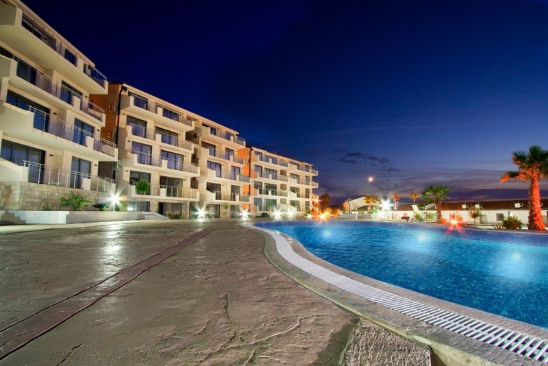 Abendansicht der Wohnanlage mit Pool und Terrassen in Pržno, Montenegro: moderne Architektur und Beleuchtung.