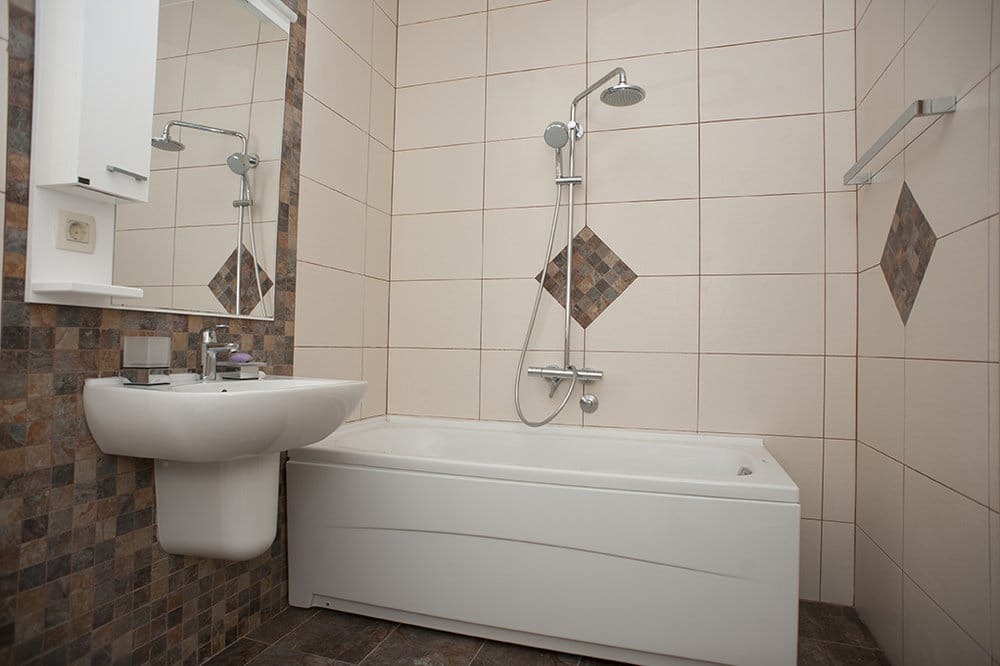 Bright bathroom with white fixtures and mosaic-style tile in a villa in Perazica Do, Montenegro.