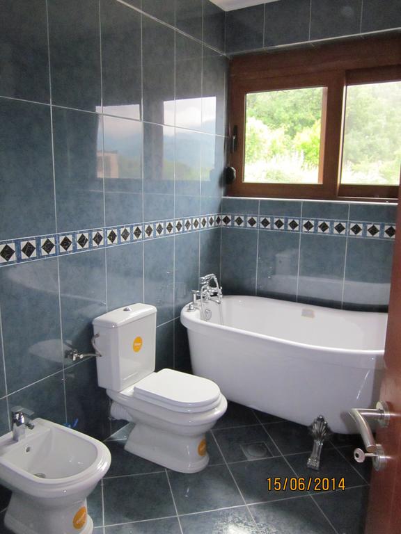 Badezimmer mit blauen Fliesen, freistehender Badewanne und Bidet in einem Haus an der Bar Riviera, Montenegro.