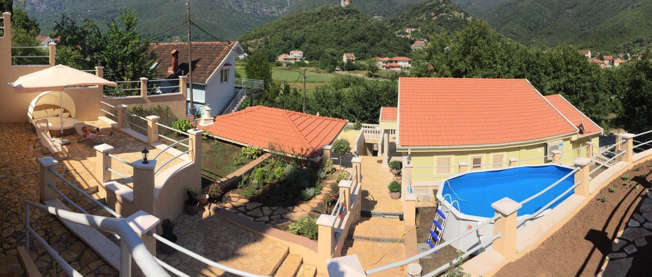 House in Zelenika, Montenegro: terrace with sun loungers, swimming pool, landscape design, and panoramic mountain views.