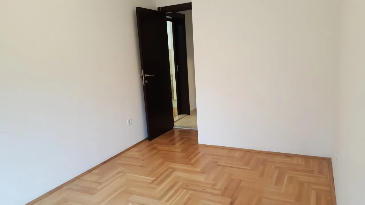 Leeres Zimmer mit Parkettboden und offener Tür