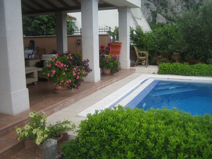 Villa terrace with a pool, garden furniture, and flowers in Orahovac, Montenegro. A cozy relaxation area by a private pool.