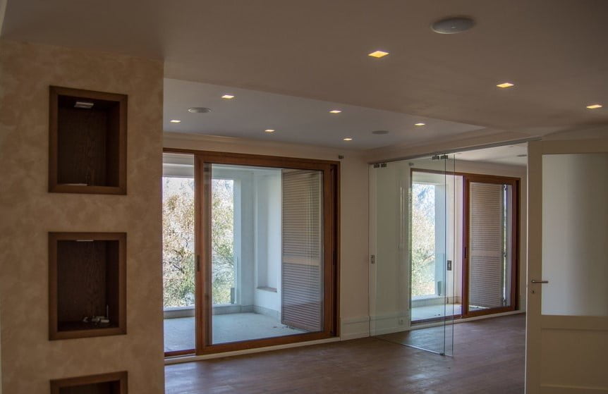 Living room with panoramic windows and access to the terrace in an elite villa, Stoliv, Montenegro: modern interior.