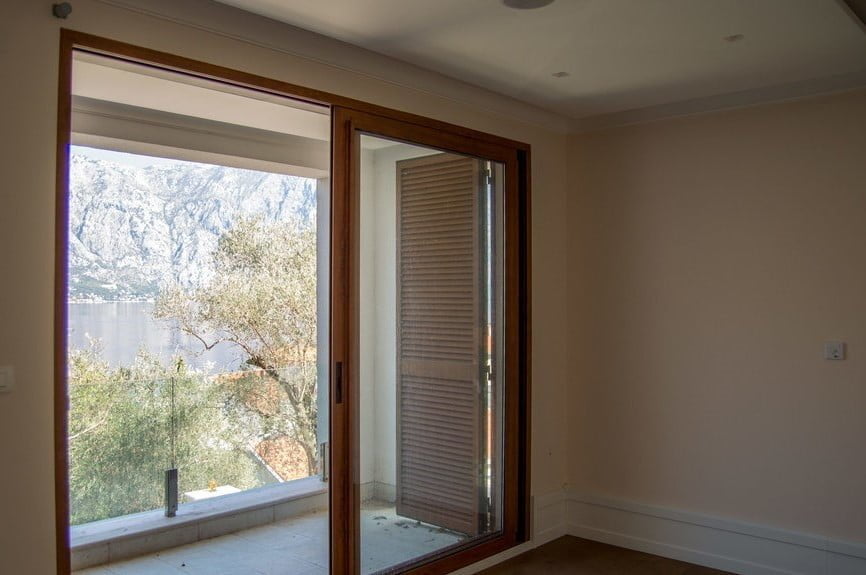 Living room with panoramic view of the Bay of Kotor and the mountains in a villa, Stoliv, Montenegro, with access to the terrace.