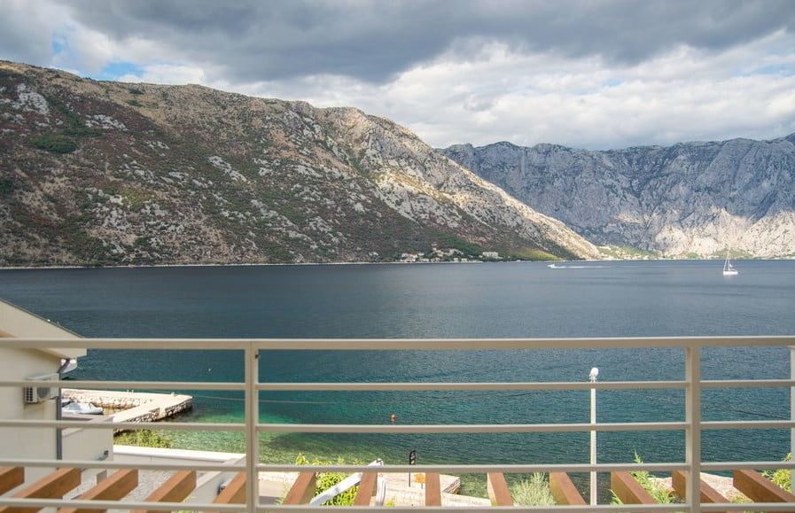 View from the villa balcony in Stoliv, Montenegro: a panorama of the Bay of Kotor, mountains, and the seacoast.