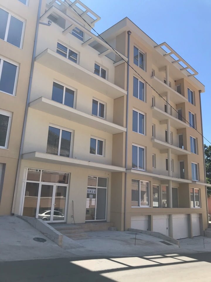 Modern residential complex with balconies and garages for sale in Bečići, Montenegro: building facade with panoramic windows