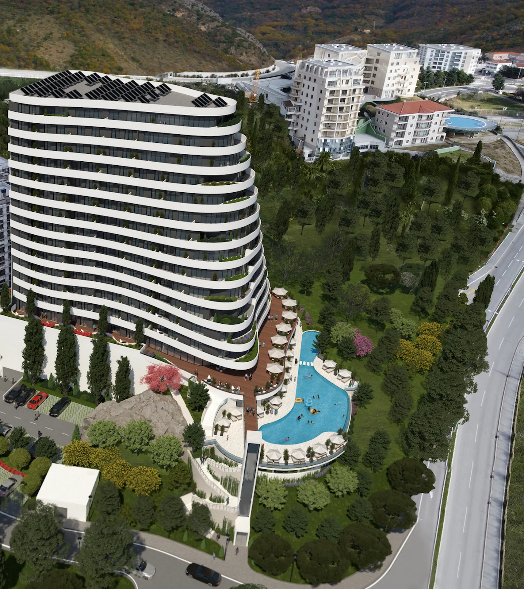 Modern residential complex in Bečići, Montenegro: panoramic view of the building with a swimming pool, terrace, and parking.