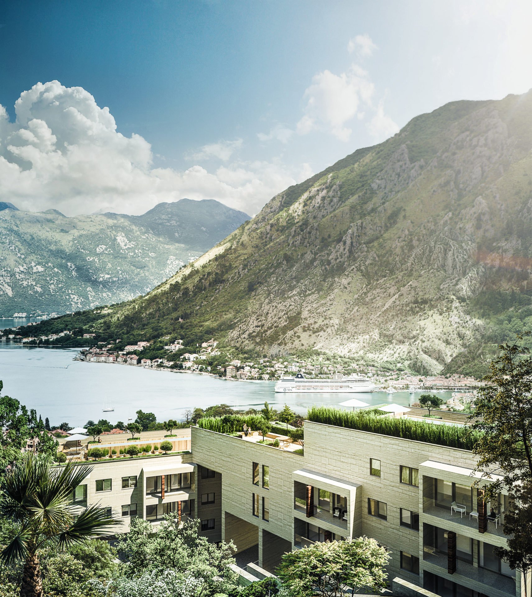 Modern residential complex in Kotor, Montenegro, with terraces and panoramic views of the Bay of Kotor and the mountains.