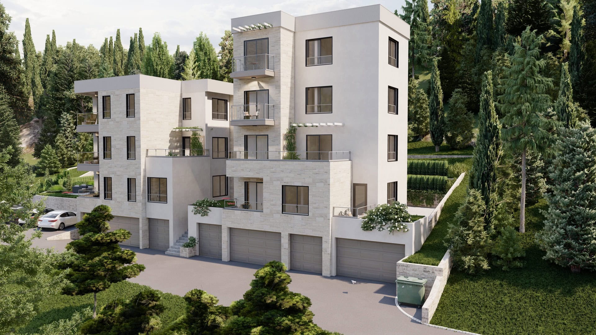 Moderner Wohnkomplex mit Terrassen und Garagen inmitten von Grün, Tivat, Montenegro, Blick auf die Fassade des Gebäudes.