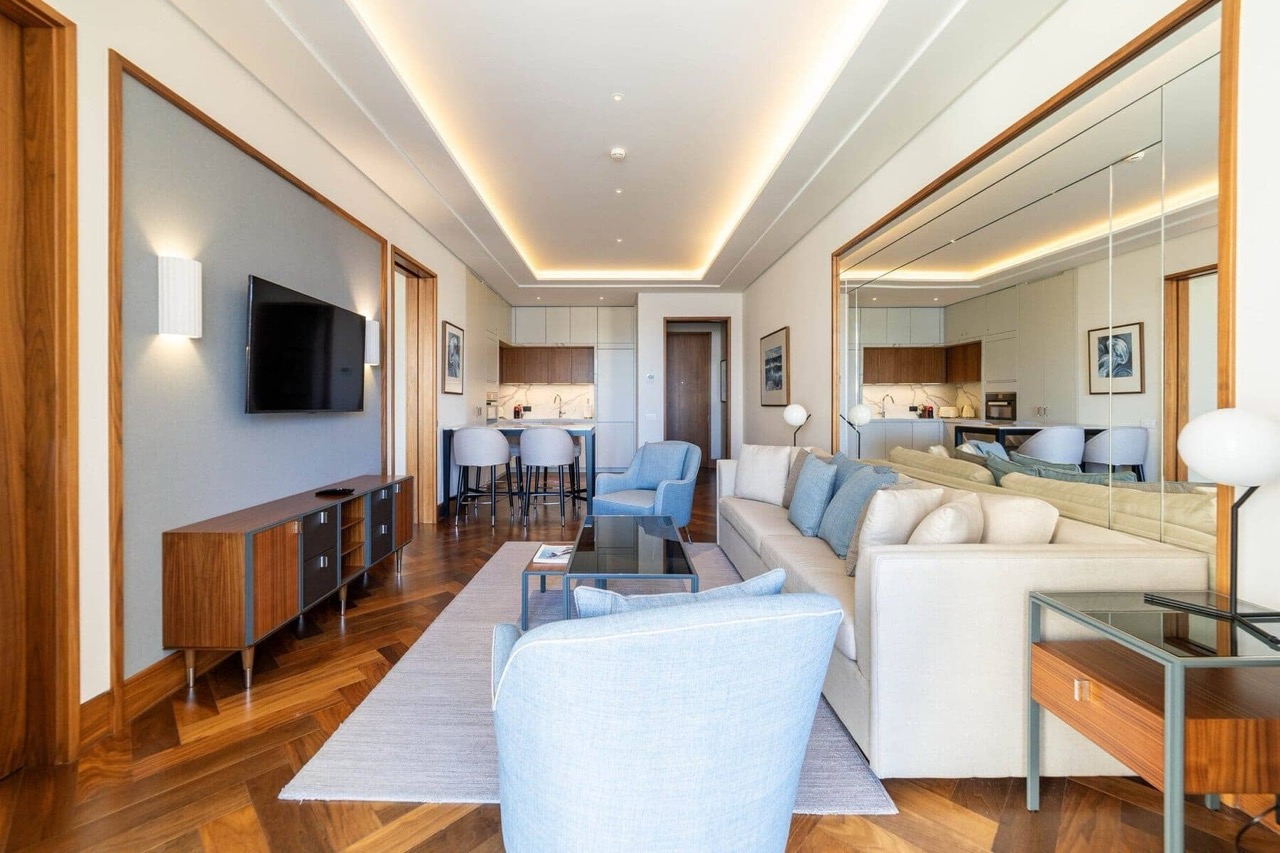 Savremeni dnevni boravak sa kuhinjom u stanu, Porto Montenegro, Tivat, Crna Gora: parket, svetao nameštaj i dekor.
