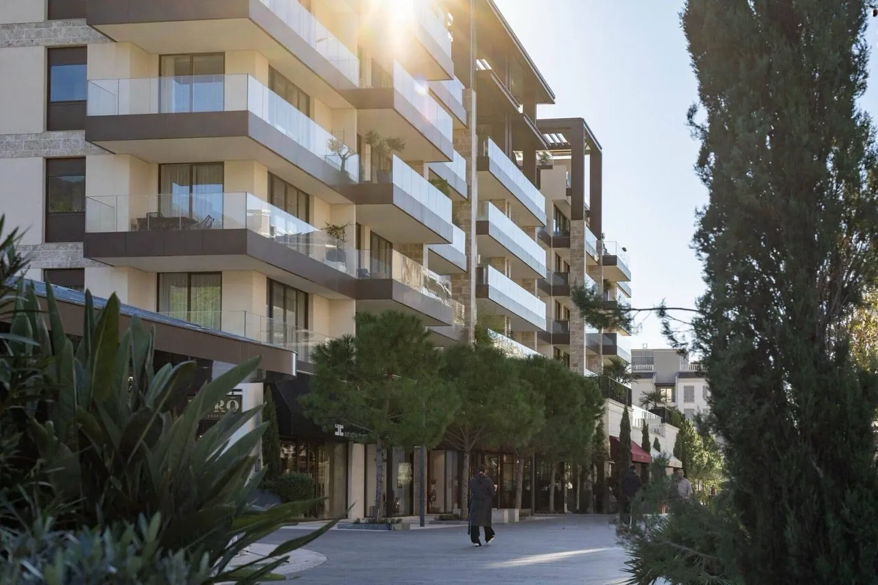 Modern residential complex in Porto Montenegro, Tivat, Montenegro: view of the building facade with terraces and the pedestrian area.