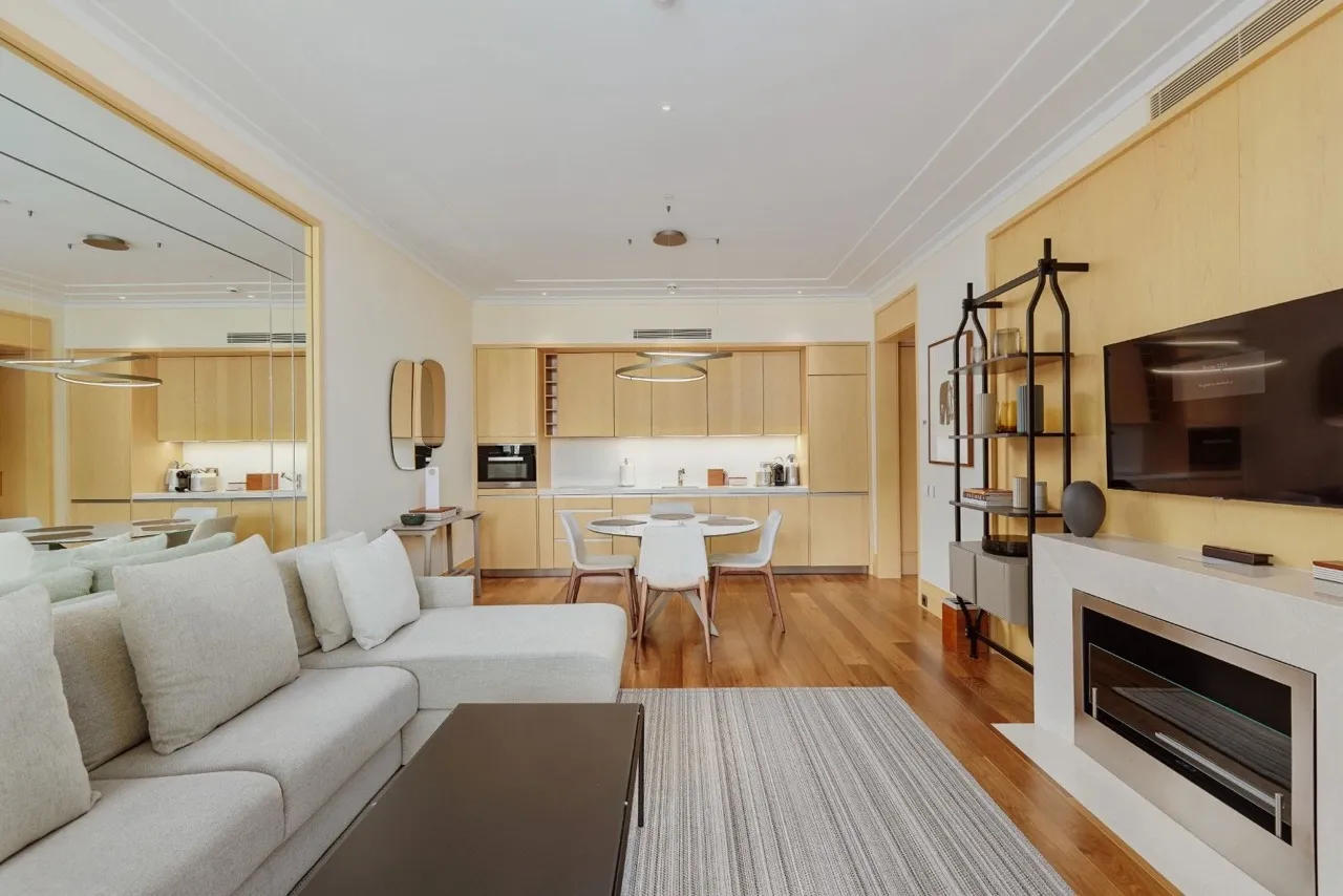 Modernes Wohnzimmer mit Kamin und Küche in einer Wohnung, Porto Montenegro, Tivat, Montenegro: stilvolles Interieur mit Möbeln.