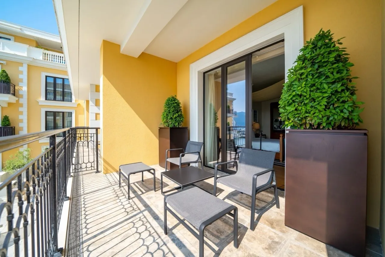 Cozy balcony with furniture in Porto Montenegro apartments, Tivat, Montenegro: marina view and modern finishes.