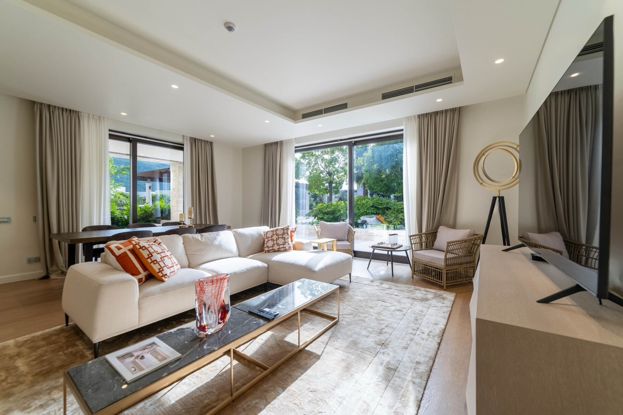 Modernes Wohnzimmer in einer Wohnung in Portonovi, Kumbor, Montenegro: helles Interieur, Panoramafenster und Terrasse.