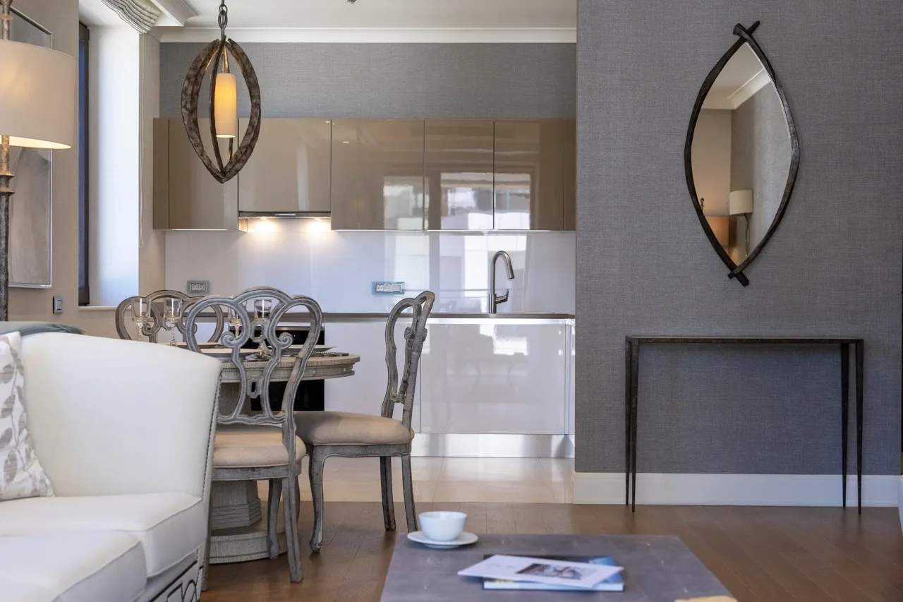 Modernes Wohnzimmer mit Küche in der Wohnung Portonovi, Kumbor, Montenegro: stilvolle Möbel, graue Tapeten und Designer-Dekor.