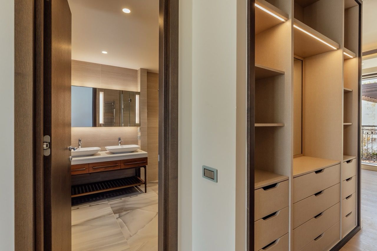 Modern walk-in closet and bathroom with double sinks in a villa in Portonovi, Kumbor, Montenegro.