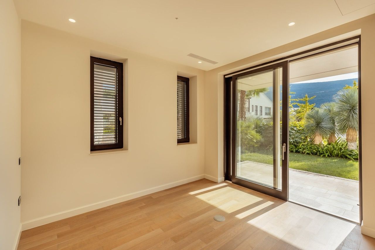 Bright living room with panoramic windows and access to the garden in a villa in Portonovi, Kumbor, Montenegro.
